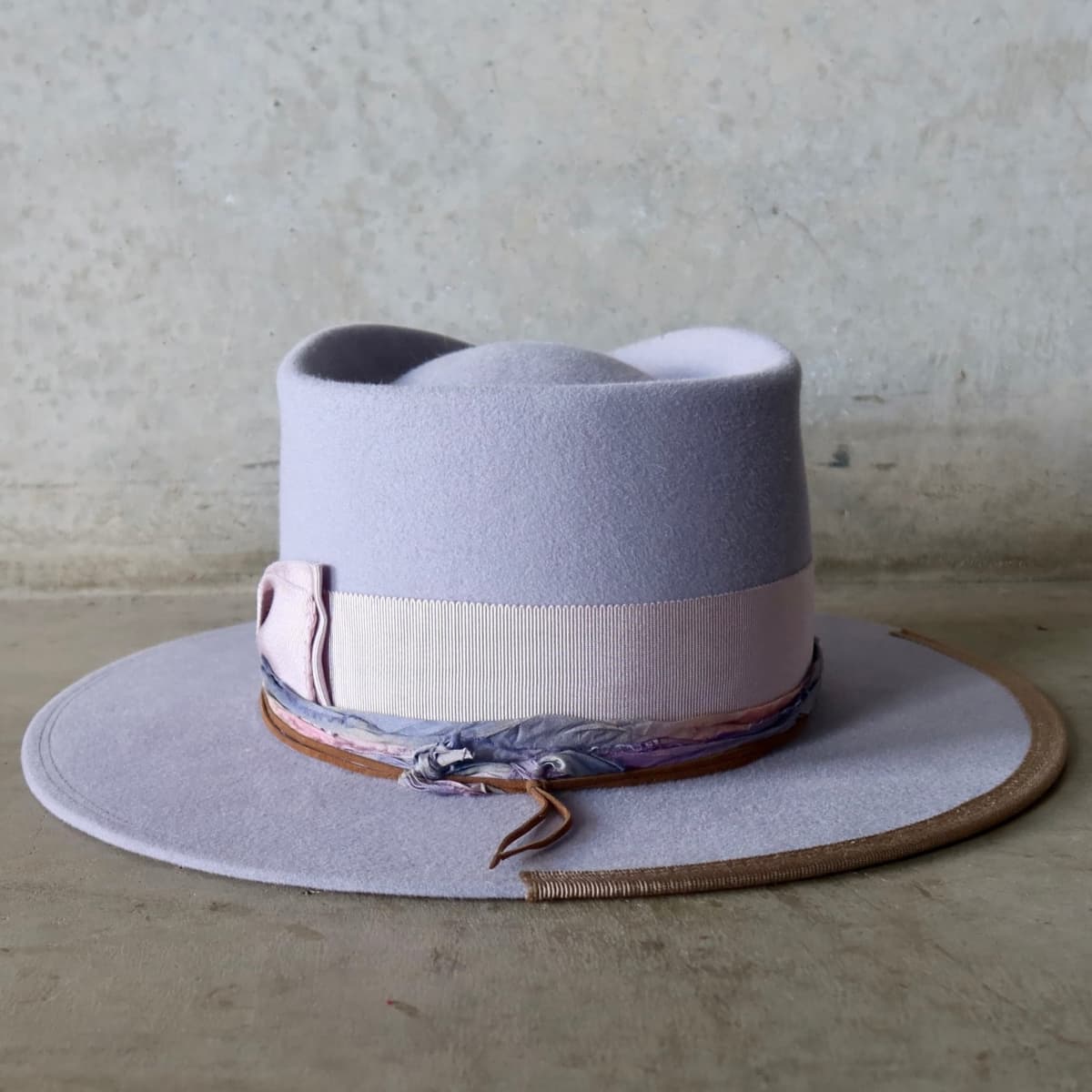 Back view of the Lilac felt hat Wolseley by PHYLLi Designs featuring lilac grosgrain double bow with blanket stitch detailing.
