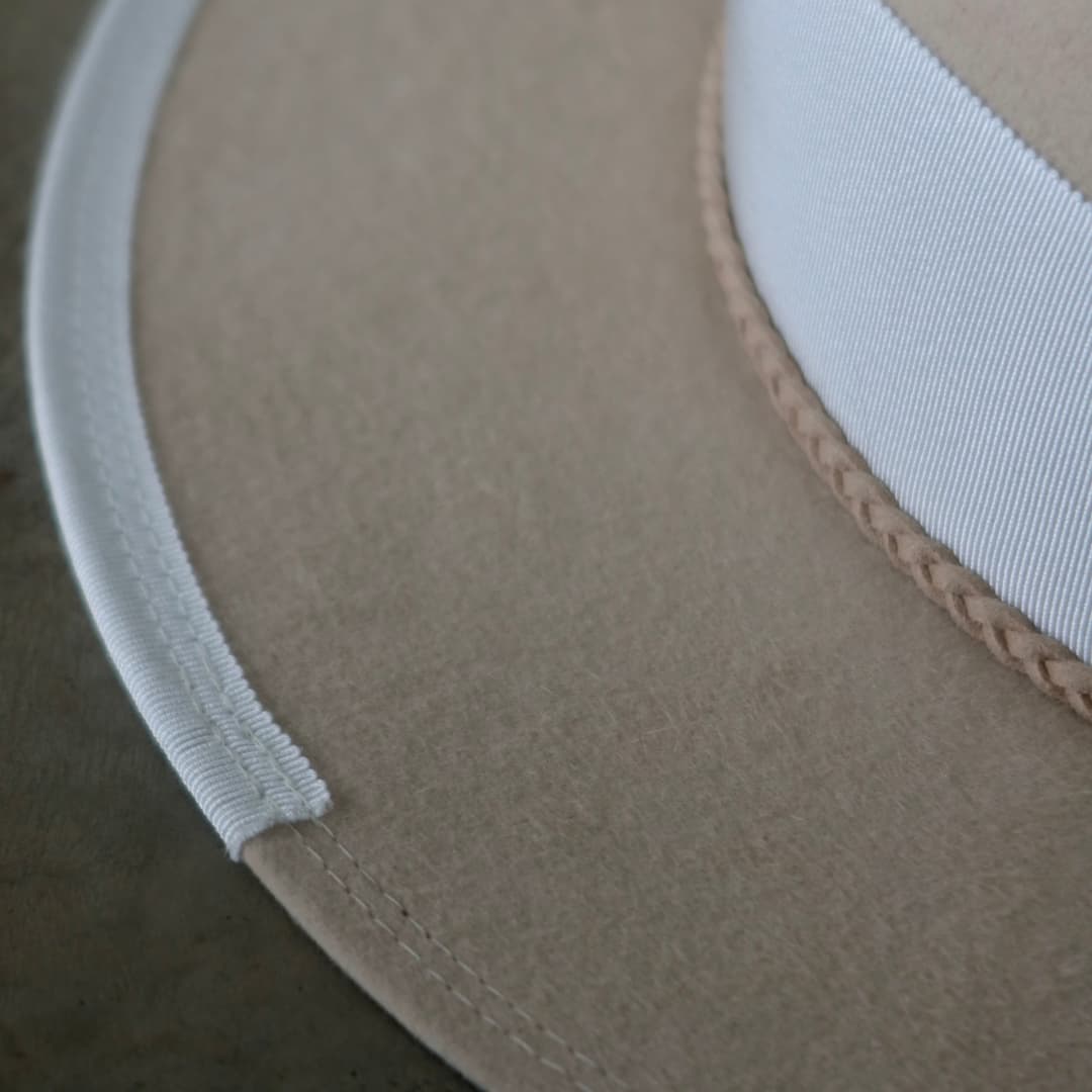 Close up detail of the Yolande felt hat showing ivory grosgrain brim trim with double brim stitching.