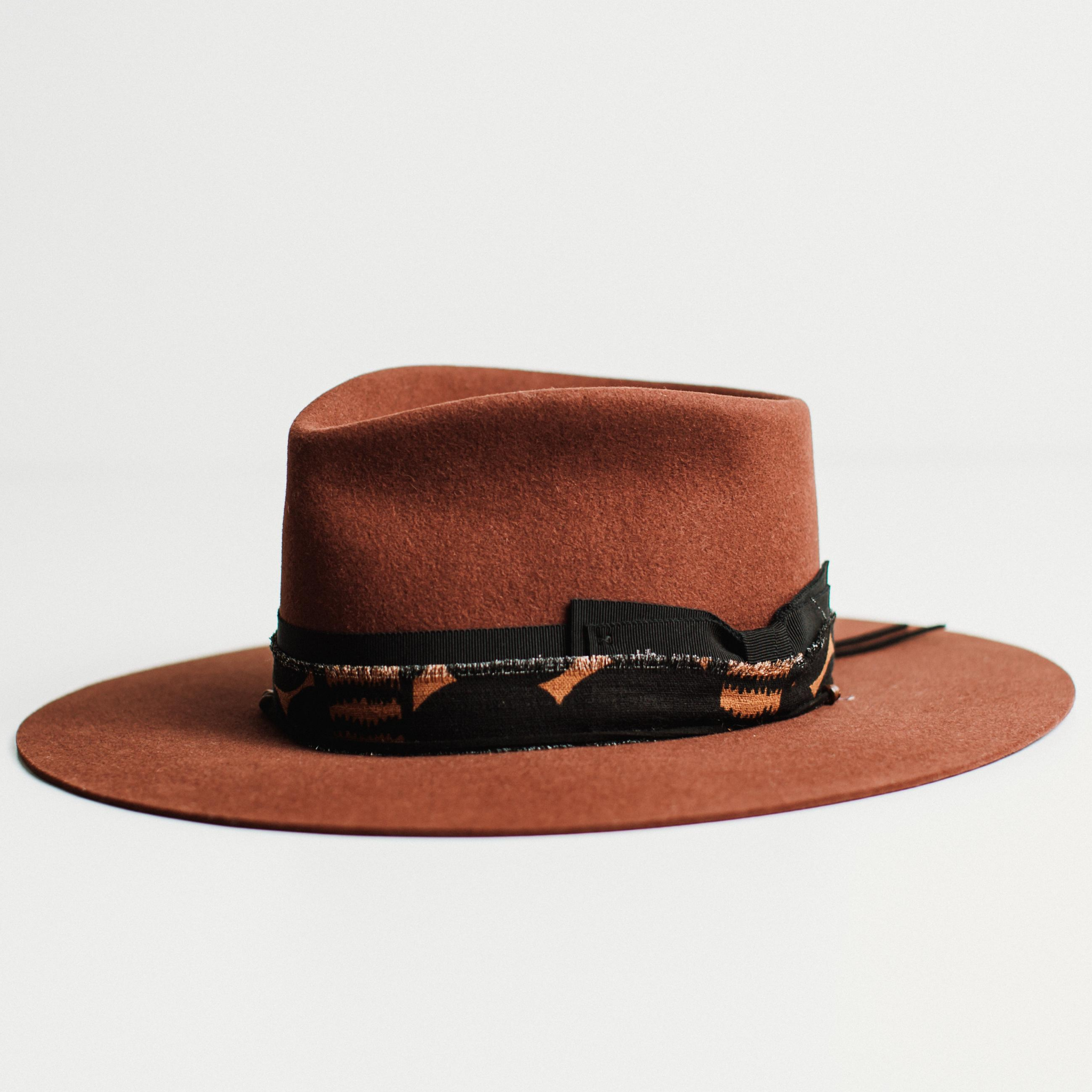 Left angle - The Artist by PHYLLi, a Russet felt hat with layered grosgrain and cotton bands, black suede and wooden beading.