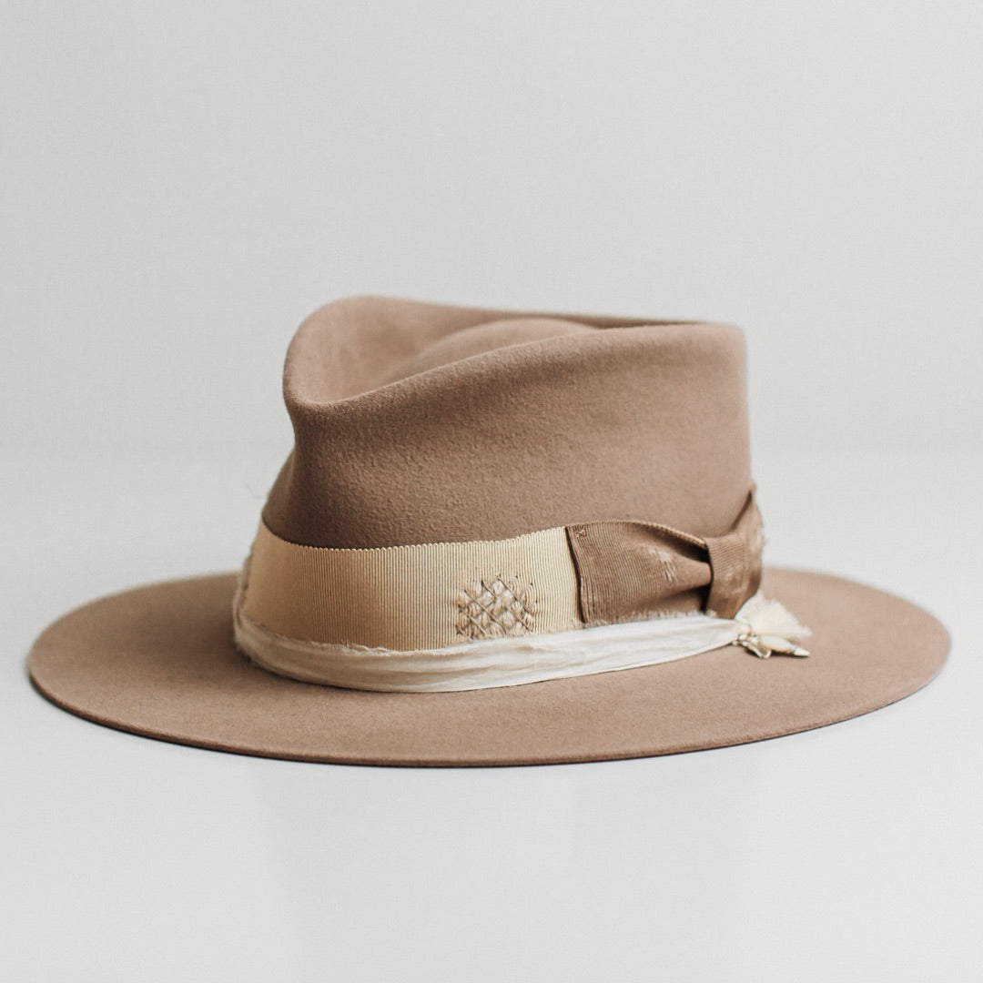 Front left angle of the Enso sahara felt hat by PHYLLi Designs with layered grosgrain band in taupe, sand and ivory.