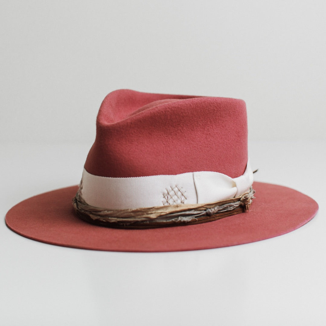 Front left angle of the Kentucky rose felt hat by PHYLLi Designs with distressed ivory grosgrain band, stone darned patch and sari silk trimming.