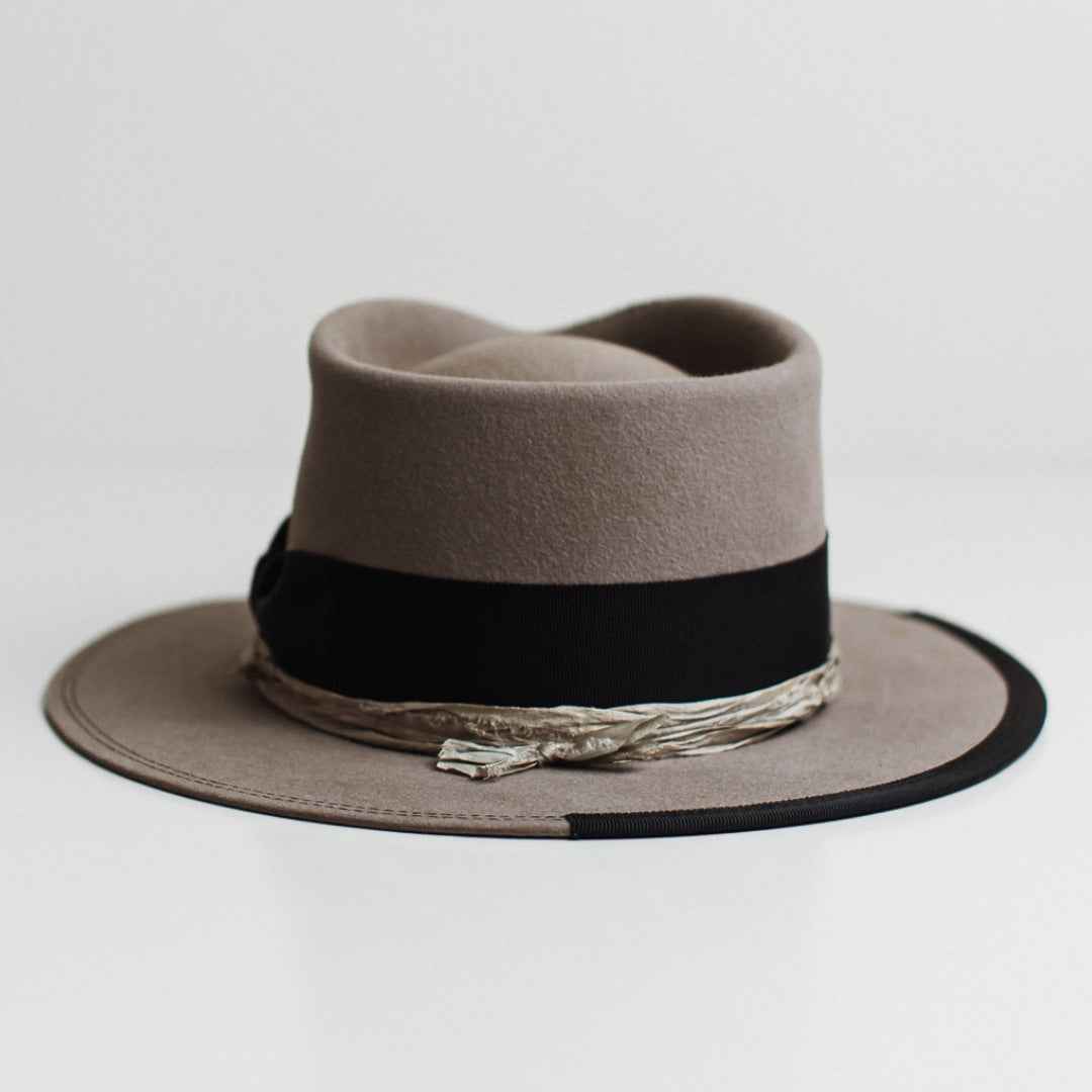 Back view of the Specter taupe distressed felt hat by PHYLLi Designs featuring smoke sari silk trimming and dark navy grosgrain band.